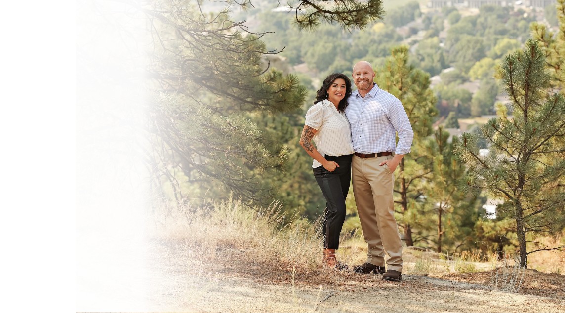 Banner image of couple at entry of home with lady opening the front door and couple smiling and looking inside